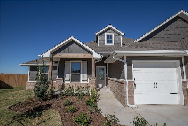 view of front of home with a front yard and a garage