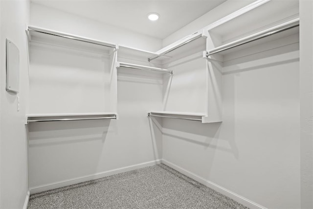 walk in closet featuring light colored carpet