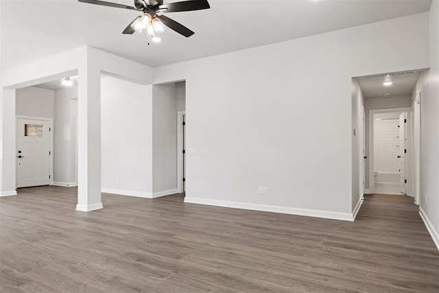 spare room featuring ceiling fan and dark wood-type flooring