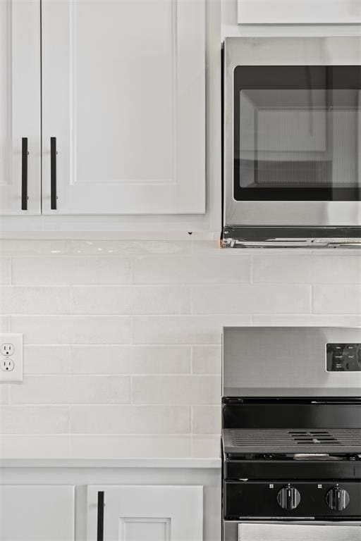 room details featuring white cabinets and stainless steel appliances