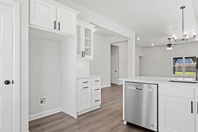 kitchen with ceiling fan with notable chandelier, white cabinets, stainless steel dishwasher, and dark hardwood / wood-style floors