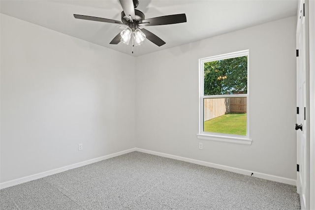 carpeted spare room featuring ceiling fan