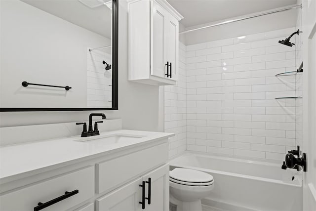 full bathroom with toilet, vanity, and tiled shower / bath