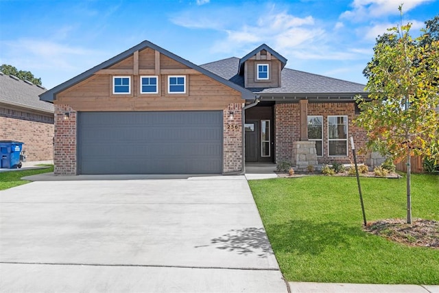 craftsman-style house featuring a garage and a front lawn