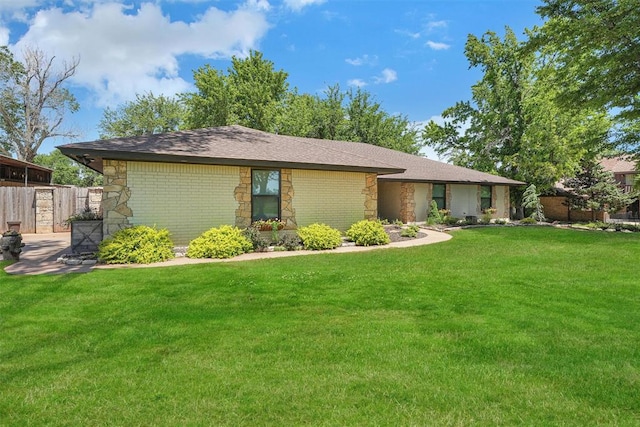 ranch-style home with a front lawn