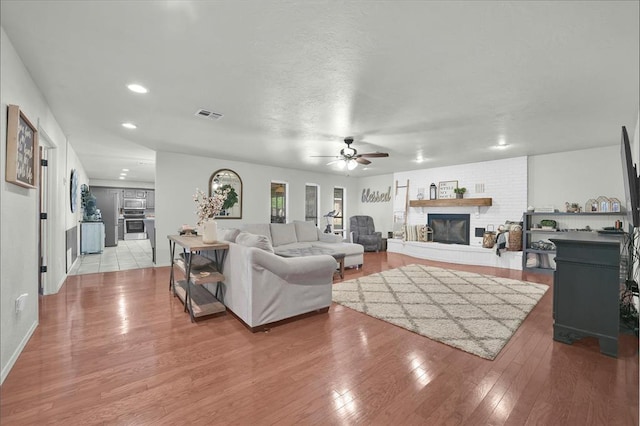 living room with ceiling fan and light hardwood / wood-style floors