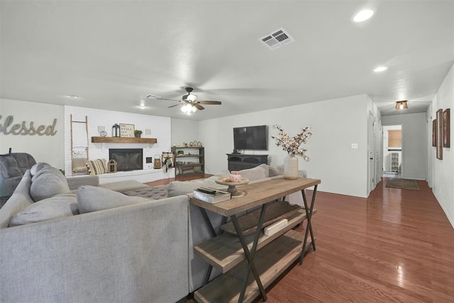 living room featuring ceiling fan and dark wood-type flooring