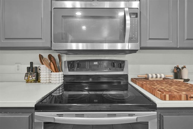 details with gray cabinetry and black range with electric cooktop