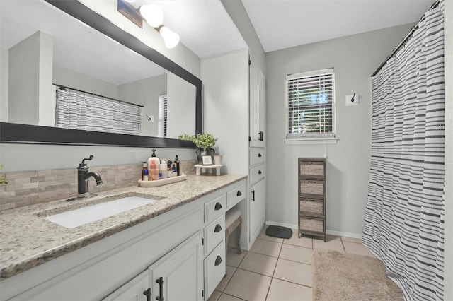 bathroom featuring vanity, backsplash, and tile patterned floors