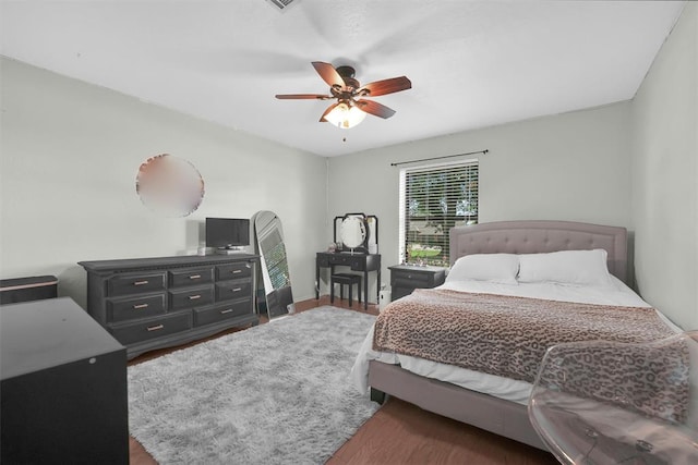 bedroom with ceiling fan and dark hardwood / wood-style floors