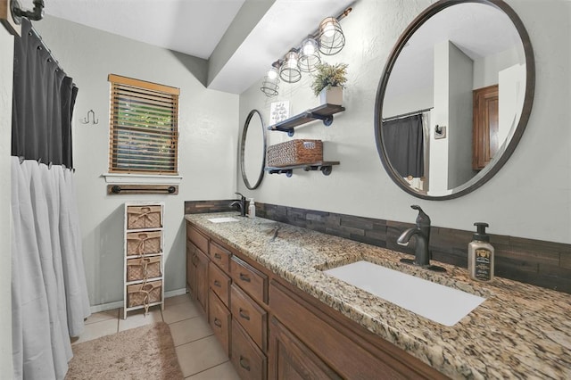 bathroom featuring tile patterned flooring and vanity