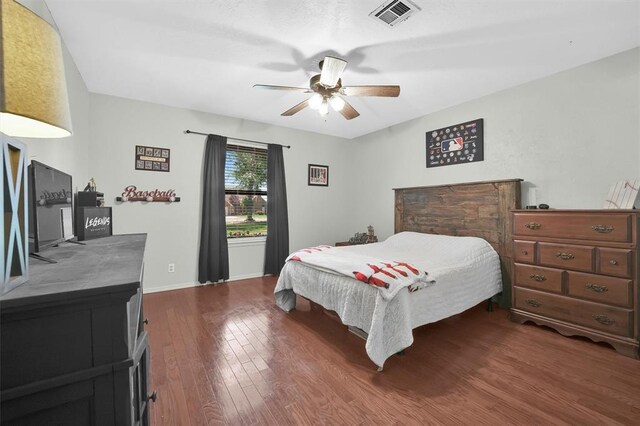 bedroom with dark hardwood / wood-style floors and ceiling fan