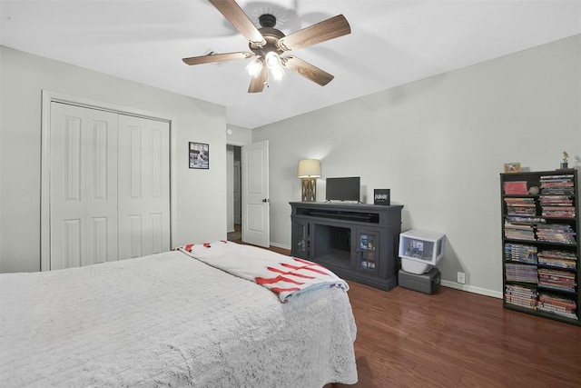 bedroom featuring ceiling fan, a closet, and dark hardwood / wood-style floors