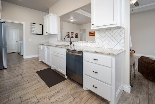 kitchen with white cabinetry, sink, appliances with stainless steel finishes, and light hardwood / wood-style flooring