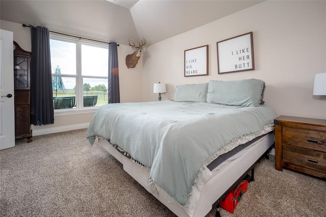 bedroom featuring carpet floors and vaulted ceiling