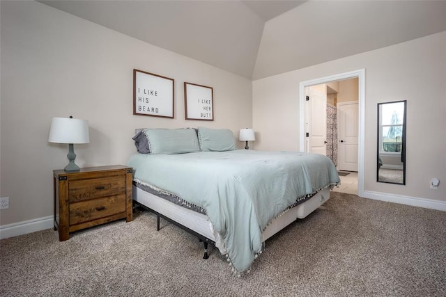 bedroom featuring carpet, lofted ceiling, and connected bathroom