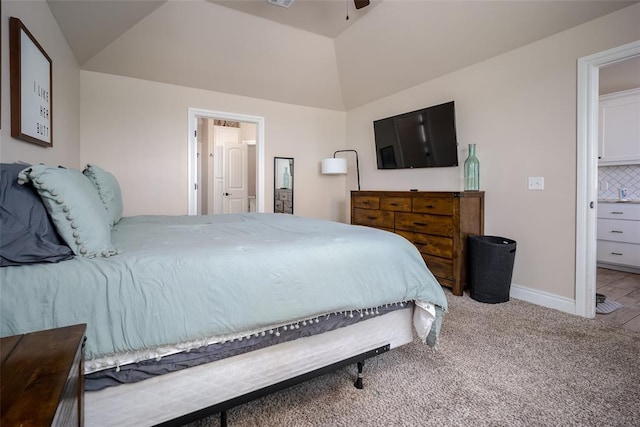 carpeted bedroom featuring ceiling fan and vaulted ceiling