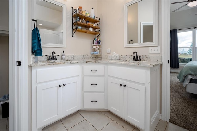 bathroom with tile patterned flooring, vanity, and ceiling fan