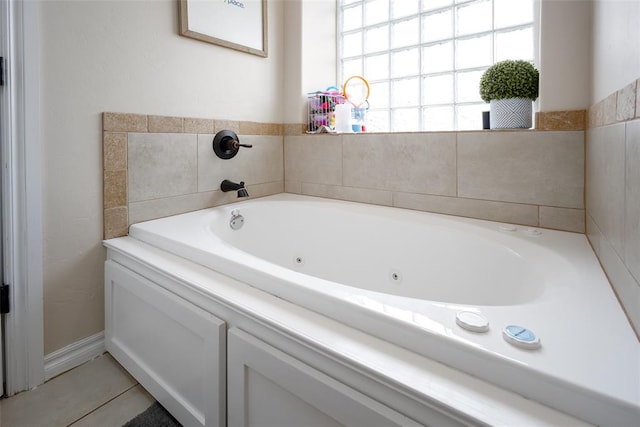 bathroom with tile patterned floors and a tub