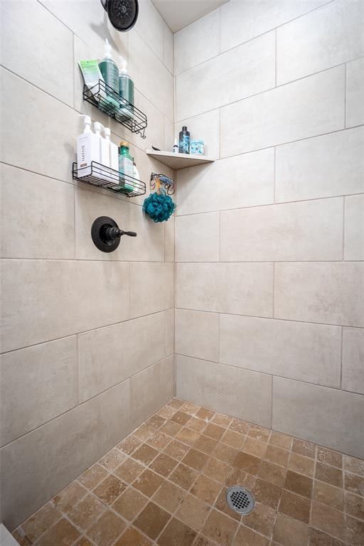 bathroom with a tile shower