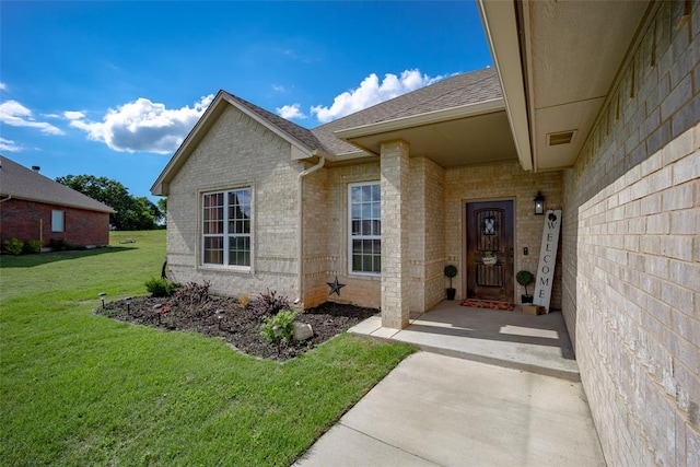 entrance to property with a yard