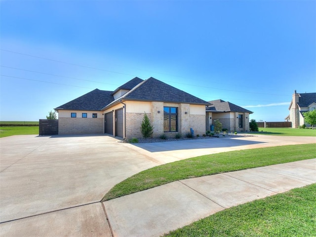 view of front of property with a garage and a front lawn