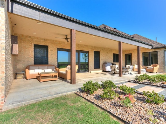 rear view of house featuring outdoor lounge area, ceiling fan, and a patio area