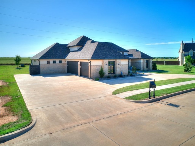 view of front of home with a front yard and a garage