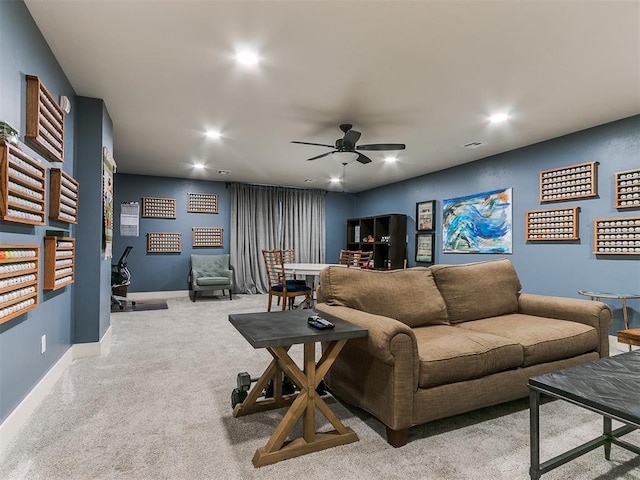 carpeted living room with ceiling fan