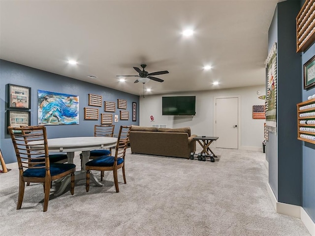 dining room with light carpet and ceiling fan