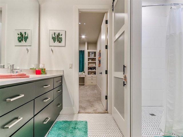 bathroom with a shower with curtain, tile patterned flooring, and vanity