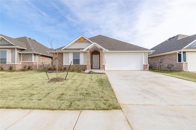 view of front of property featuring a garage and a front lawn