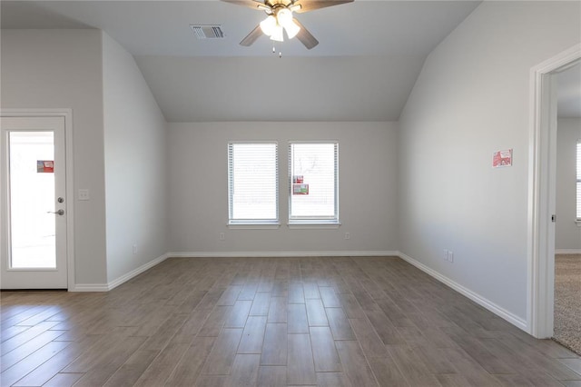 empty room with ceiling fan and lofted ceiling