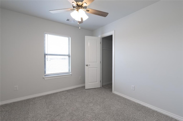 spare room with ceiling fan and carpet floors