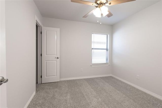 spare room featuring ceiling fan and light colored carpet