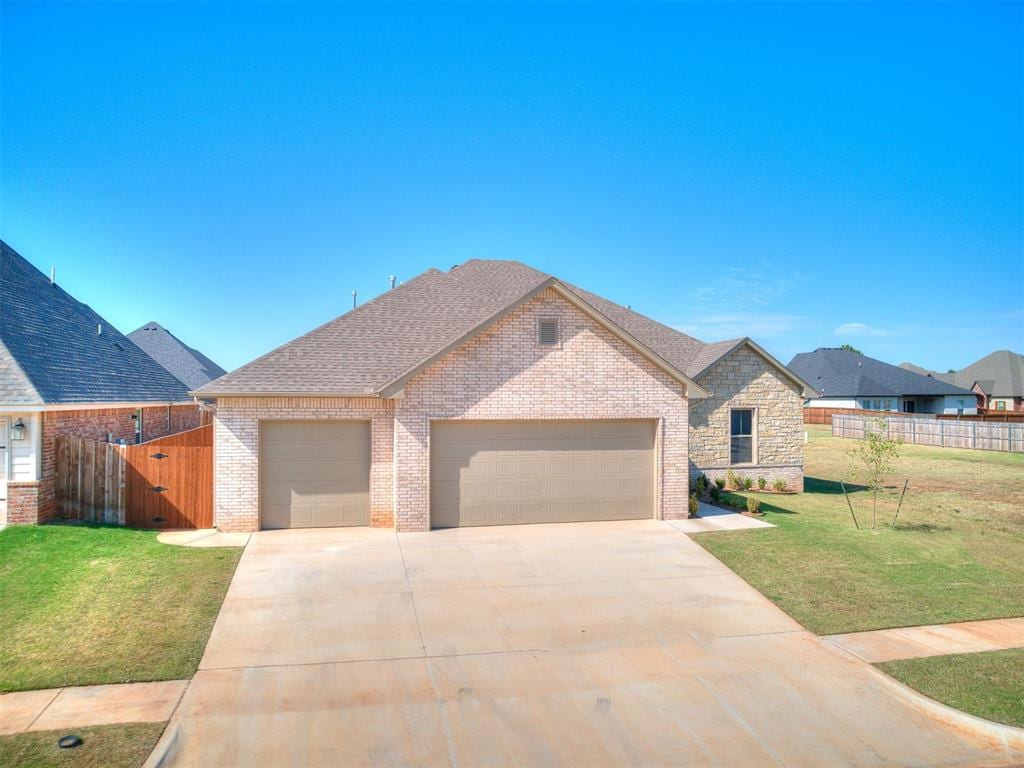 view of front facade with a front yard and a garage