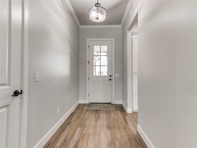 doorway to outside featuring light wood-type flooring and crown molding