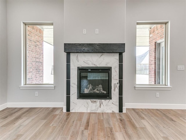 interior details with hardwood / wood-style flooring and a premium fireplace