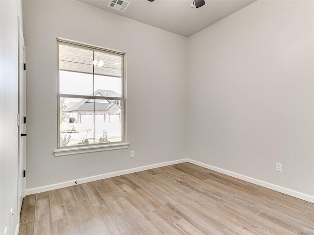 spare room with light hardwood / wood-style flooring and ceiling fan