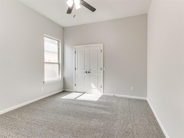 empty room with carpet flooring and ceiling fan