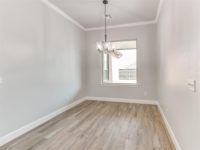 spare room with light hardwood / wood-style flooring, a chandelier, and ornamental molding