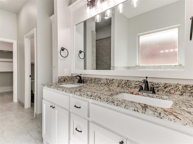 bathroom featuring tile patterned flooring, vanity, and toilet