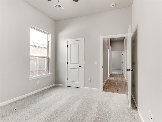 unfurnished bedroom featuring ceiling fan and light carpet