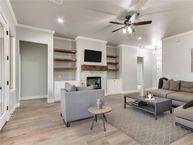 living room with ceiling fan, light hardwood / wood-style floors, and ornamental molding