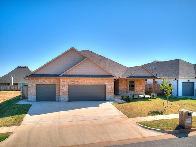 view of front of property with a garage and a front lawn