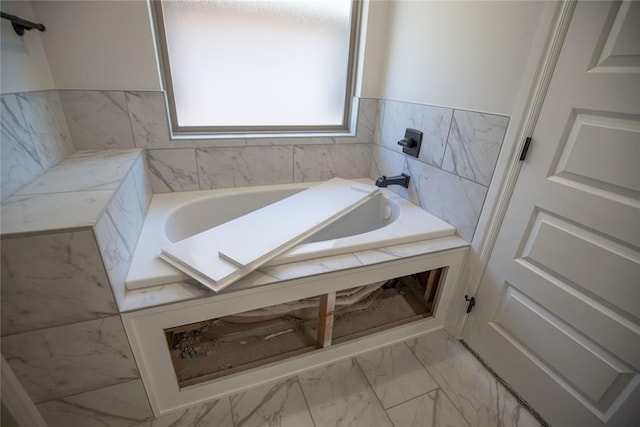 bathroom with a tub to relax in