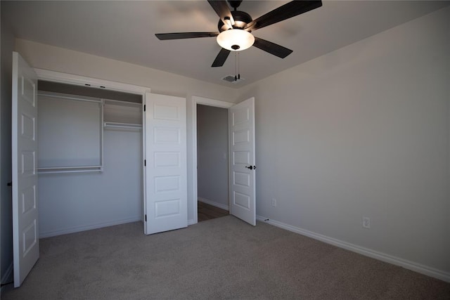 unfurnished bedroom with carpet, ceiling fan, and a closet