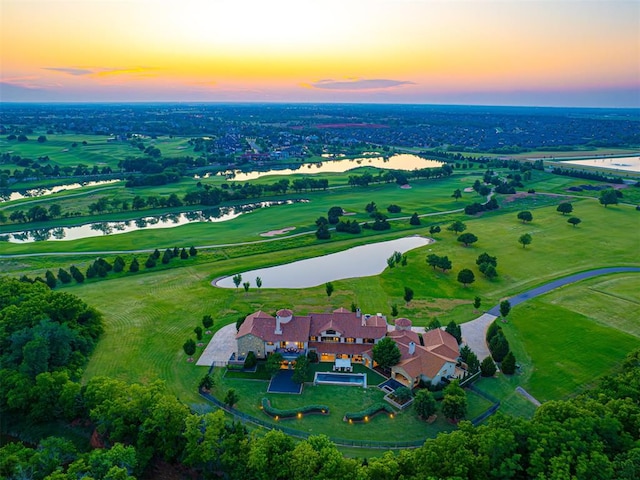 aerial view at dusk with a water view