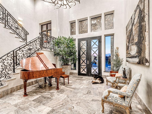 entrance foyer with a towering ceiling and french doors