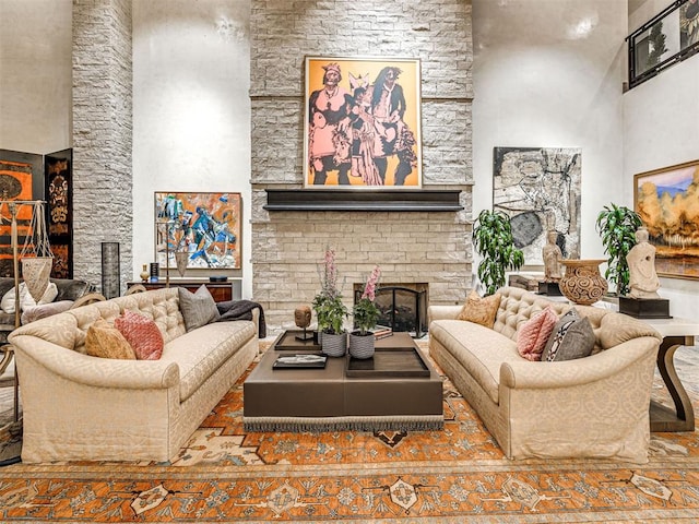 living room featuring a fireplace and a high ceiling